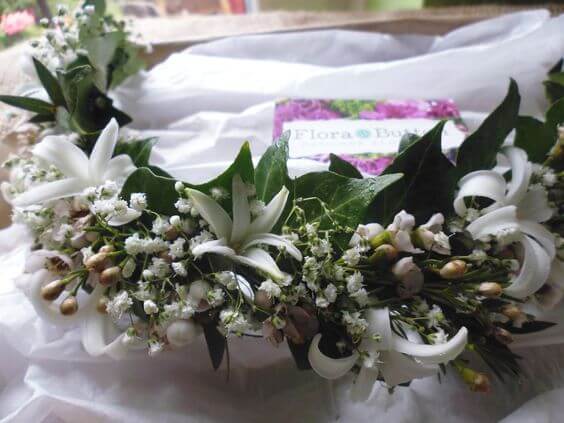 Close up of white and green flower crown head piece